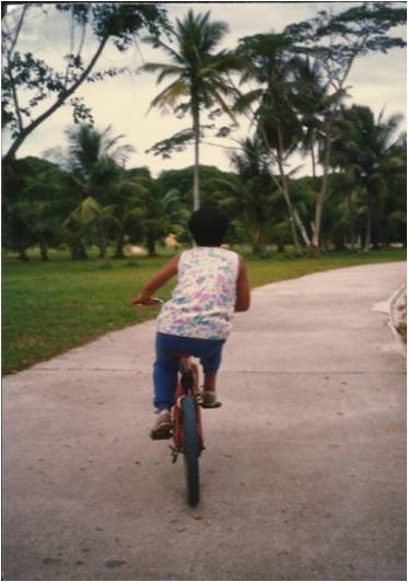 Young Ter Cheah cycling at the park